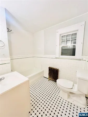 a bathroom with a sink a toilet and a shower