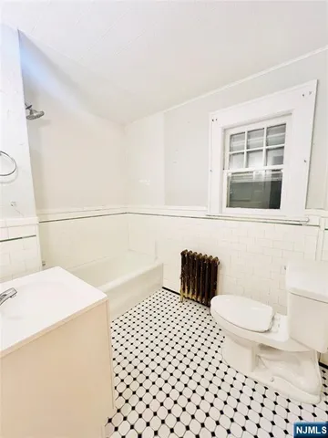 a bathroom with a sink a toilet and a shower