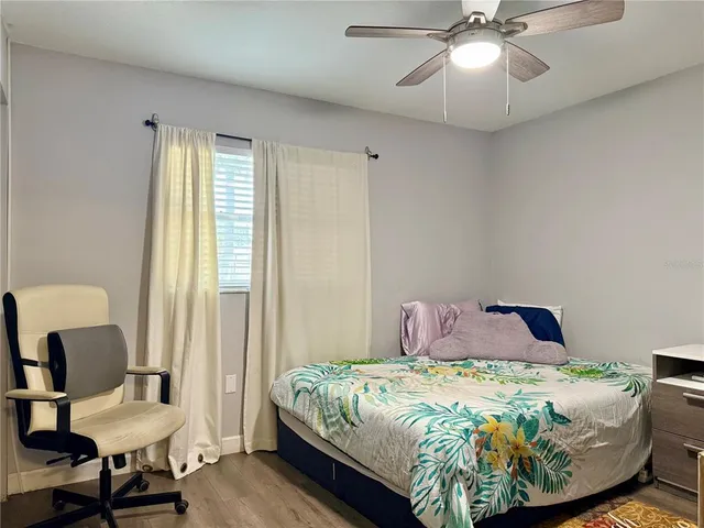 a bedroom with a bed and a chair