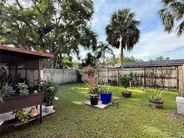 a view of a chair and tables in the patio in front of a house