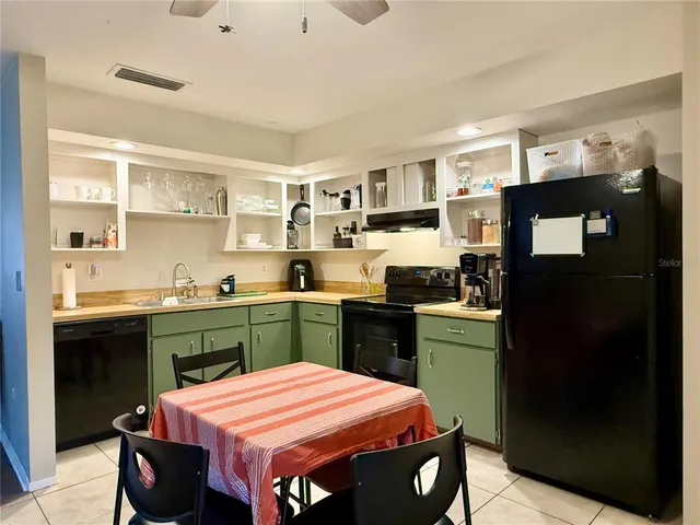a kitchen with a sink appliances and cabinets