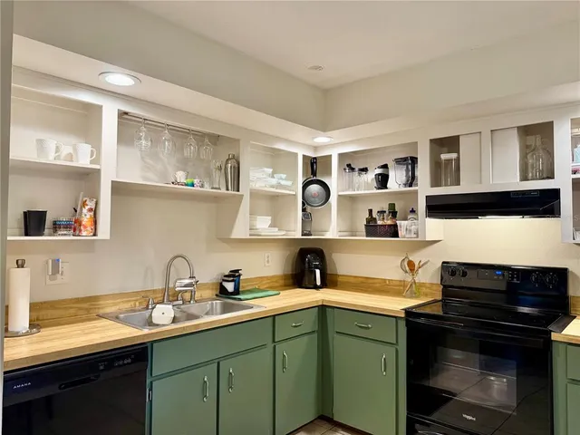 a kitchen with stainless steel appliances a sink and cabinets