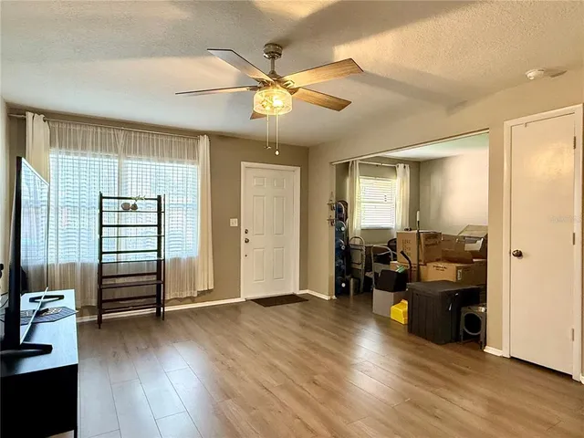 a view of a livingroom with furniture and hardwood floor