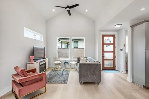 a living room with furniture and wooden floor