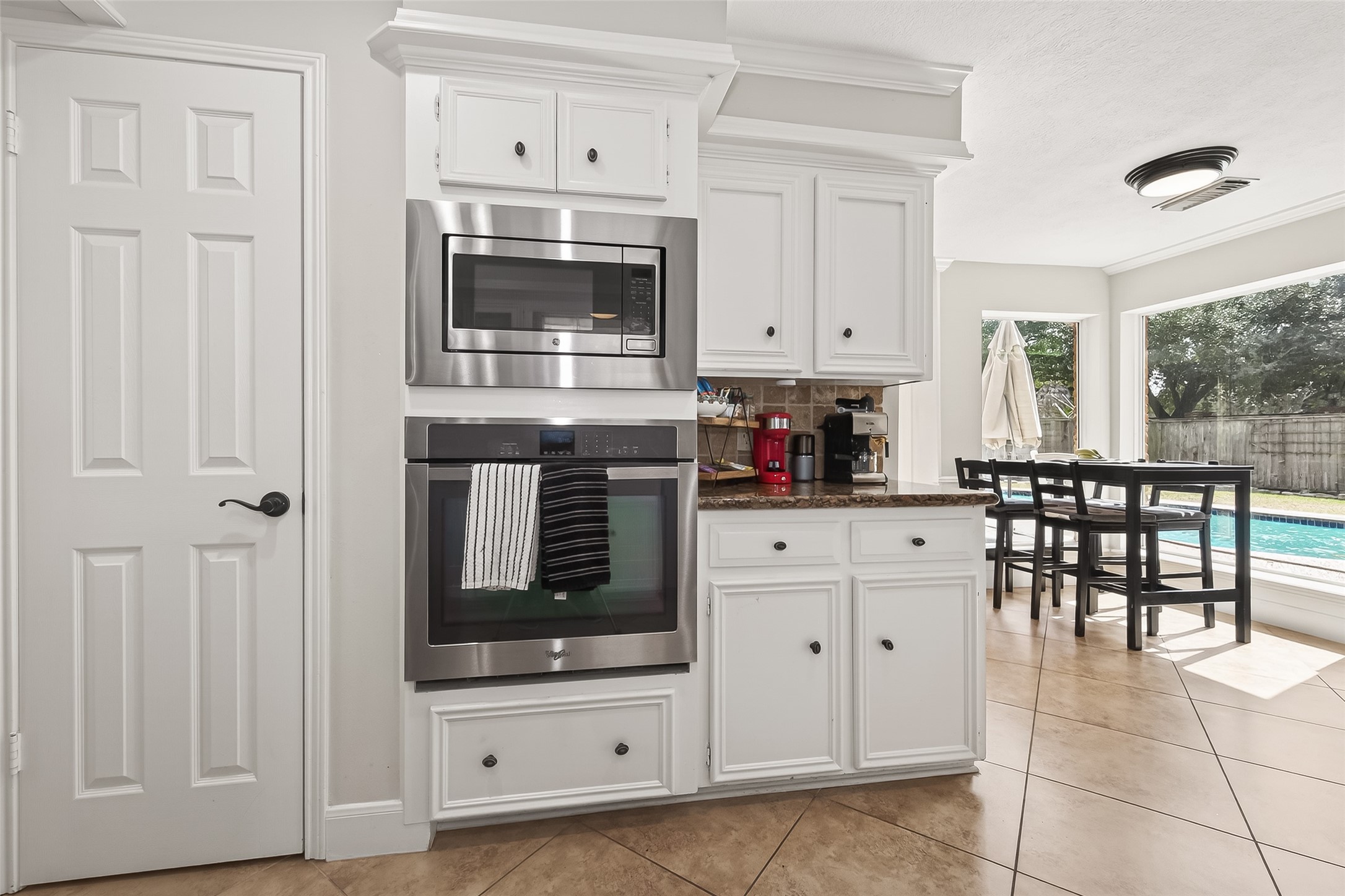 15843 Foxgate Road Houston, TX 77079 - Photo 21 of 49 a kitchen with white cabinets and appliances