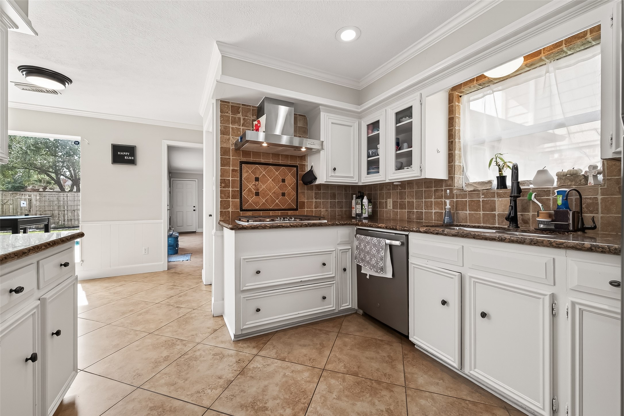 15843 Foxgate Road Houston, TX 77079 - Photo 22 of 49 a kitchen with cabinets and window