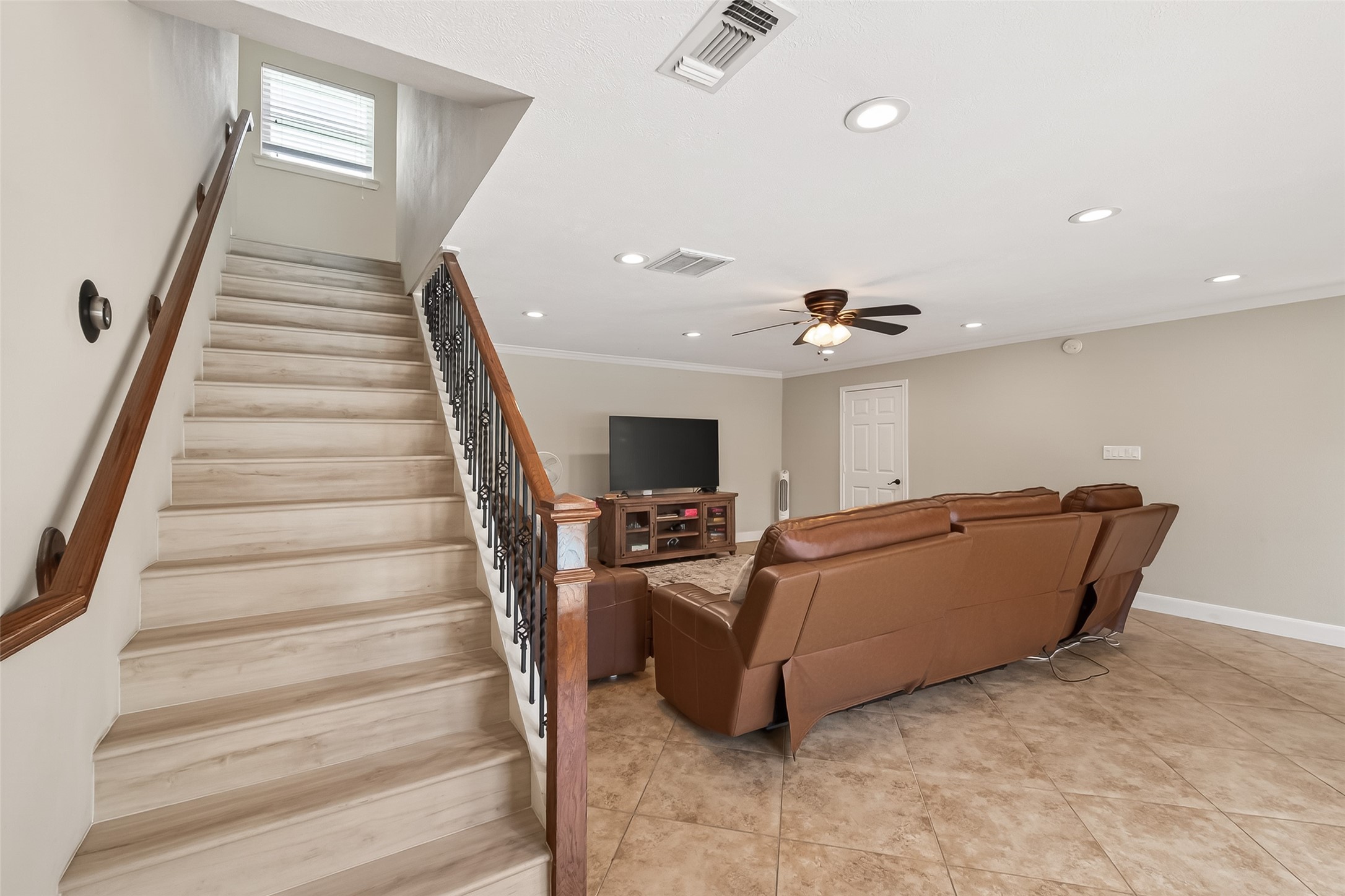 15843 Foxgate Road Houston, TX 77079 - Photo 24 of 49 a living room with furniture and a ceiling fan