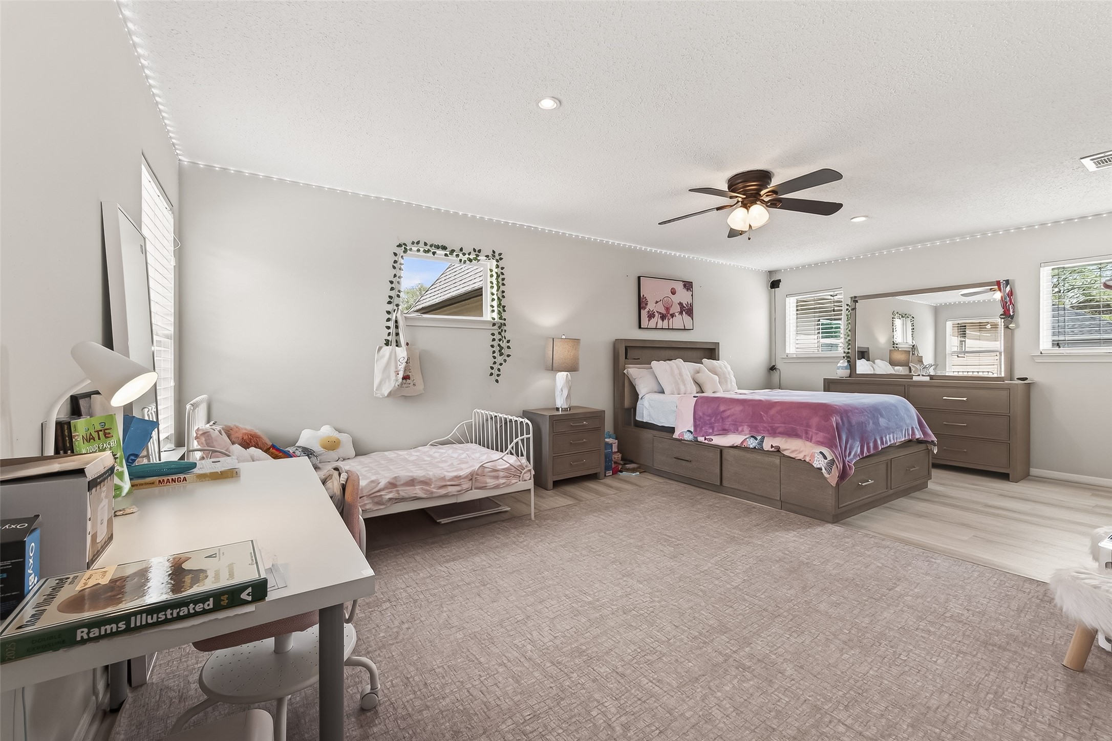 15843 Foxgate Road Houston, TX 77079 - Photo 29 of 49 a bedroom with a bed and a chandelier