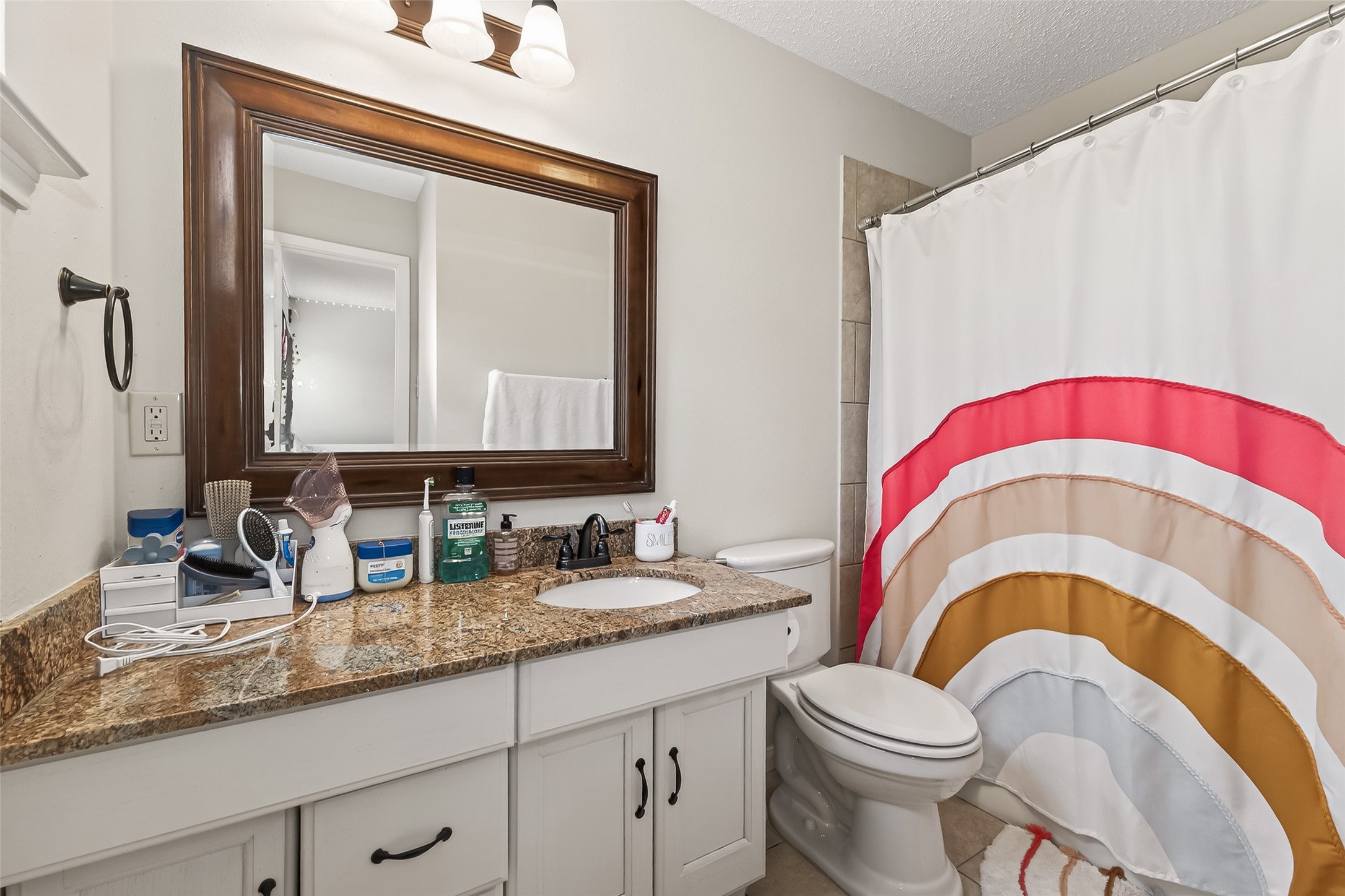 15843 Foxgate Road Houston, TX 77079 - Photo 31 of 49 a bathroom with a toilet a sink and a mirror