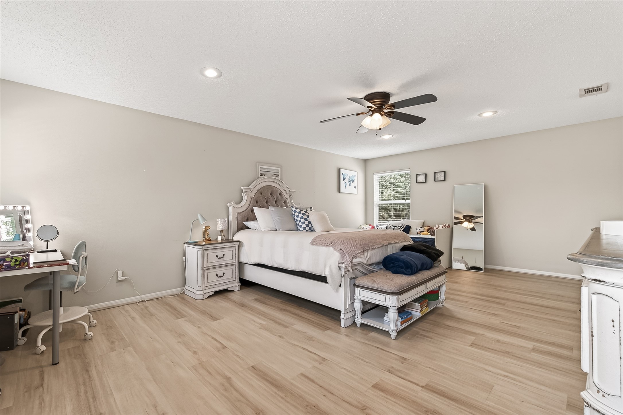 15843 Foxgate Road Houston, TX 77079 - Photo 33 of 49 a bedroom with a bed and a chandelier