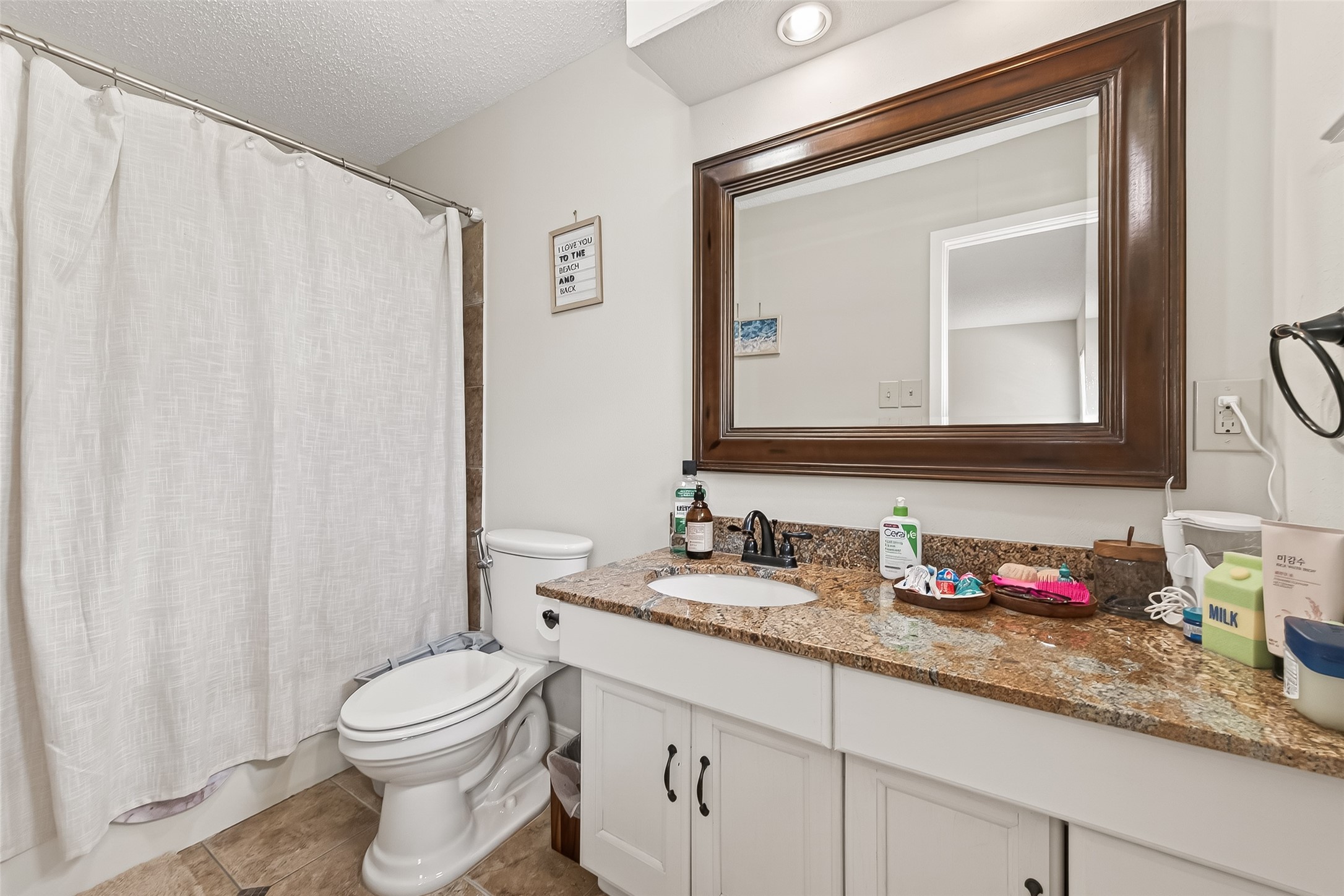 15843 Foxgate Road Houston, TX 77079 - Photo 34 of 49 a bathroom with a granite countertop sink vanity mirror and toilet