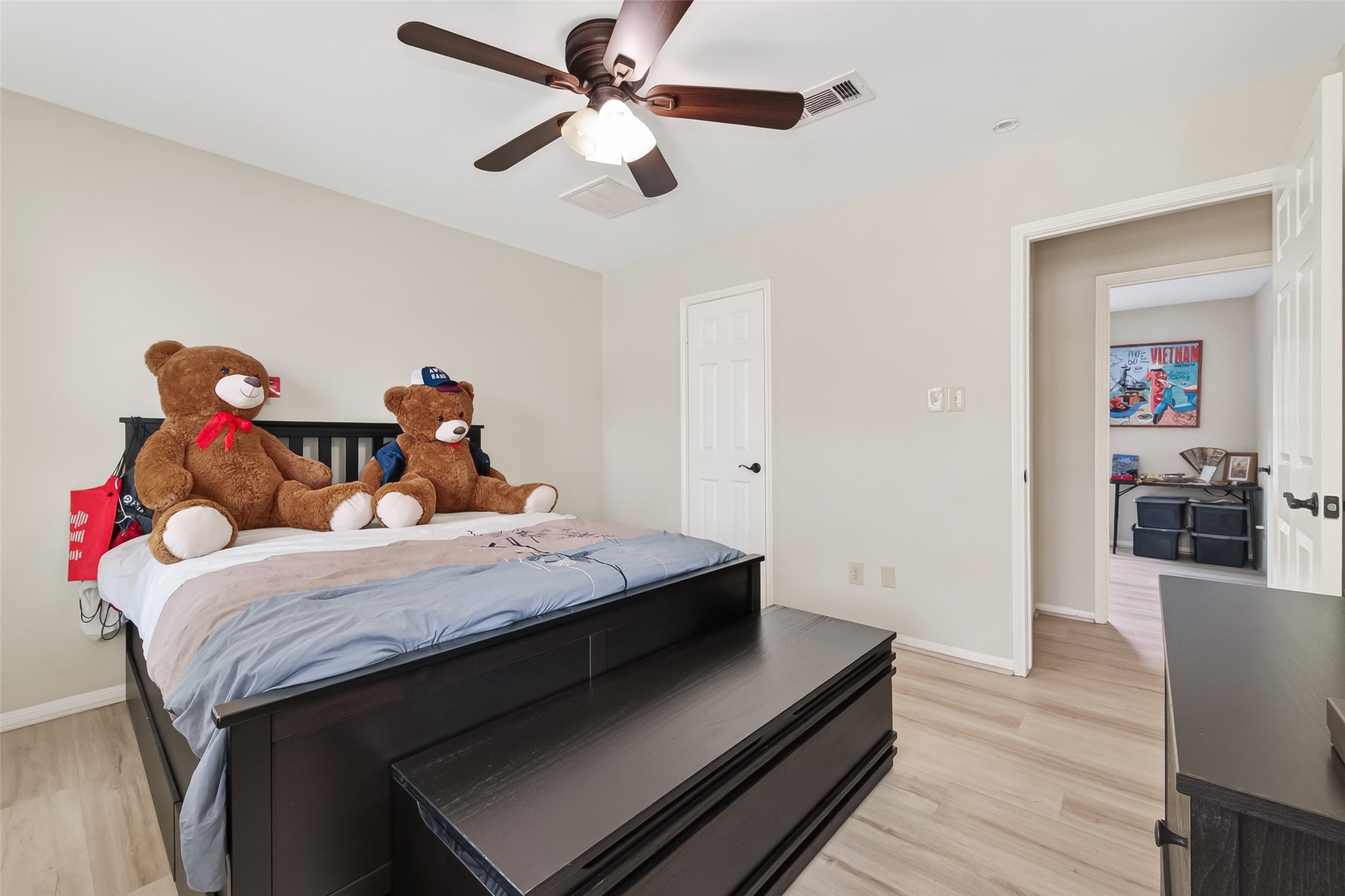 15843 Foxgate Road Houston, TX 77079 - Photo 39 of 49 a bedroom with a bed and wooden floor