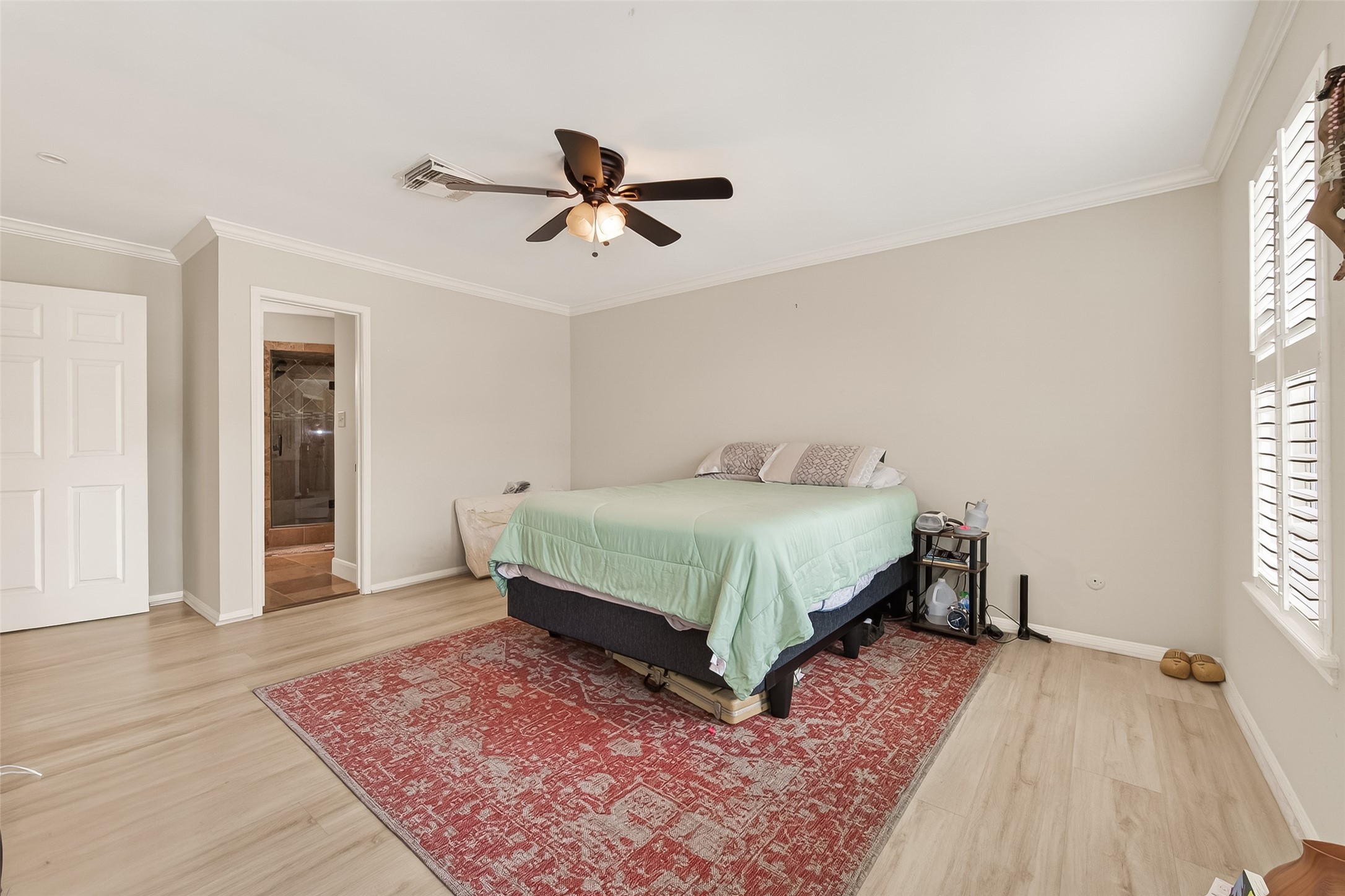 15843 Foxgate Road Houston, TX 77079 - Photo 42 of 49 a bedroom with a bed and wooden floor