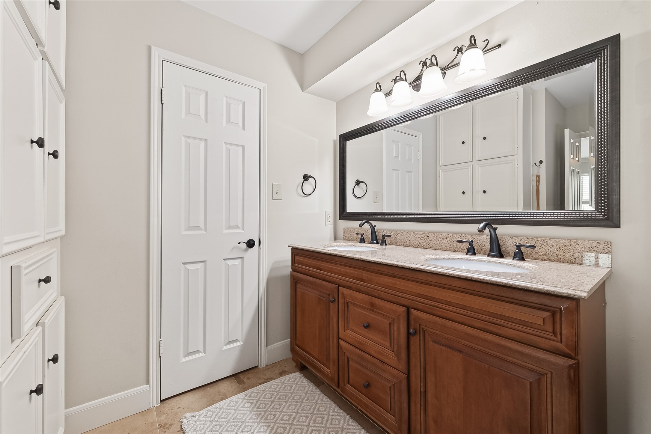 15843 Foxgate Road Houston, TX 77079 - Photo 44 of 49 a bathroom with a sink vanity and a mirror