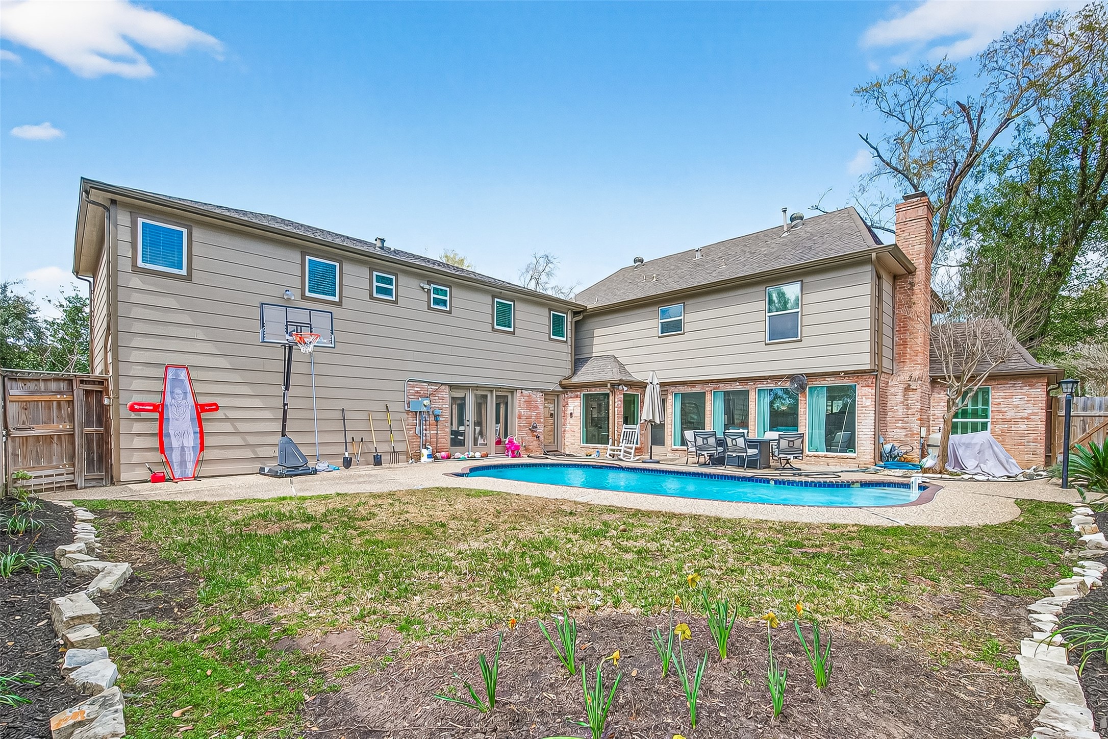 15843 Foxgate Road Houston, TX 77079 - Photo 46 of 49 a front view of a house with a yard table and chairs