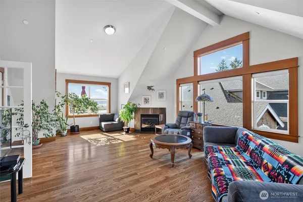 a living room with furniture a fireplace and a floor to ceiling window