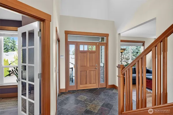 a view of an entryway with wooden floor and windows