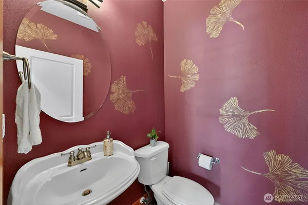 a bathroom with a sink a mirror and a toilet