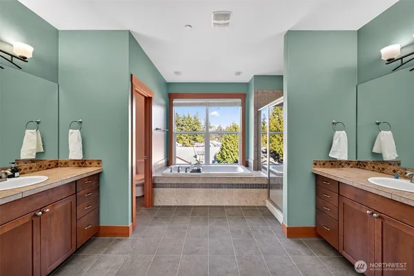 a view of a double vanity sink and a window