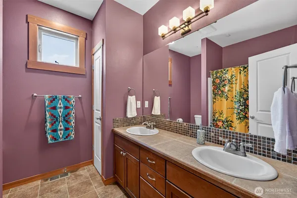 a bathroom with a sink double vanity and a mirror