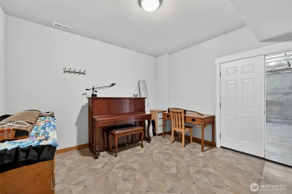 a living room with furniture and a piano