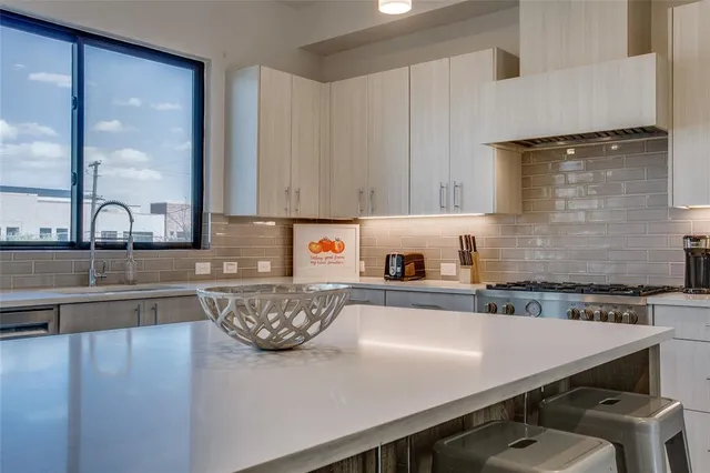 a kitchen with a sink a stove and cabinets