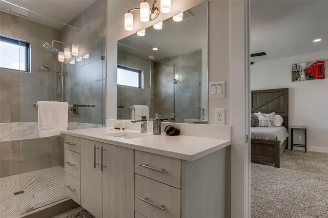 a bathroom with a sink a light fixture and a mirror