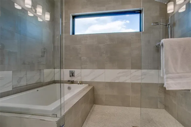 a bathroom with a bathtub and shower