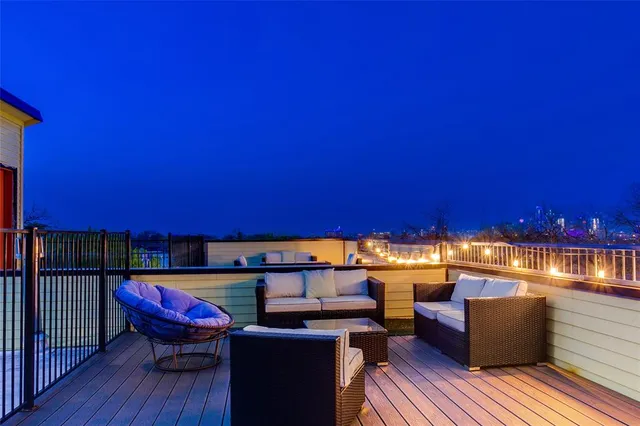 a view of a balcony with chair and wooden floor