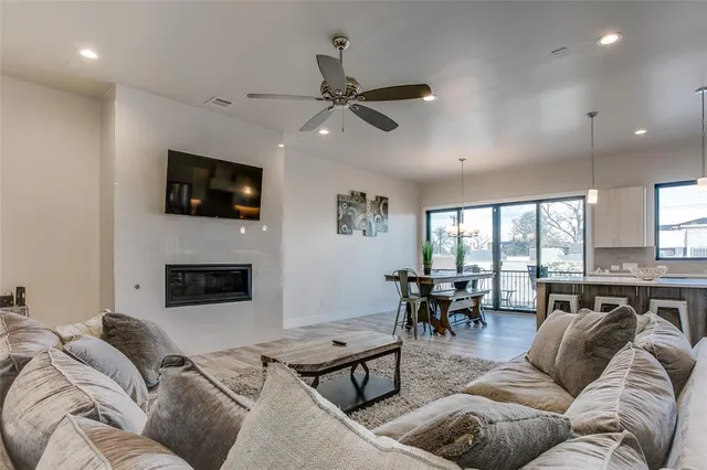 a living room with furniture fireplace and a flat screen tv