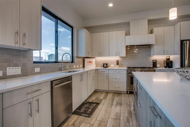 a kitchen with a sink stove and cabinets