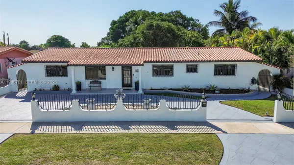 a view of a house with swimming pool and sitting area