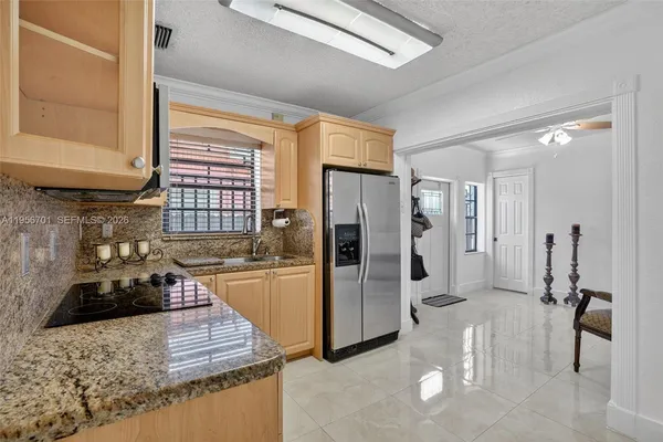 a kitchen with refrigerator and window