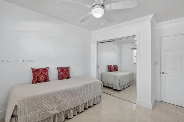 a bedroom with two beds and white walls