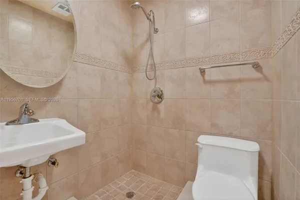 a bathroom with a sink a toilet and a mirror