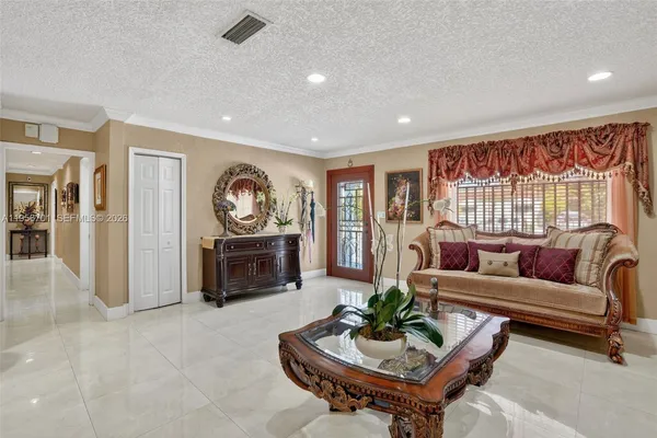 a living room with furniture a rug and a large window
