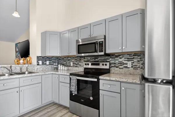a kitchen with a sink stove and microwave