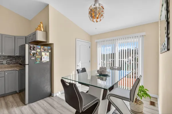 a view of a balcony and dining room