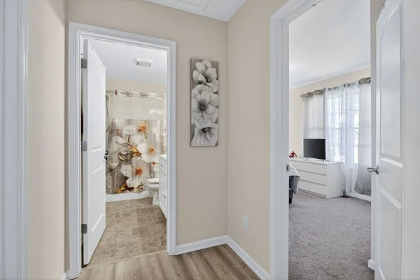 a bedroom with a bed and a lamp with the table