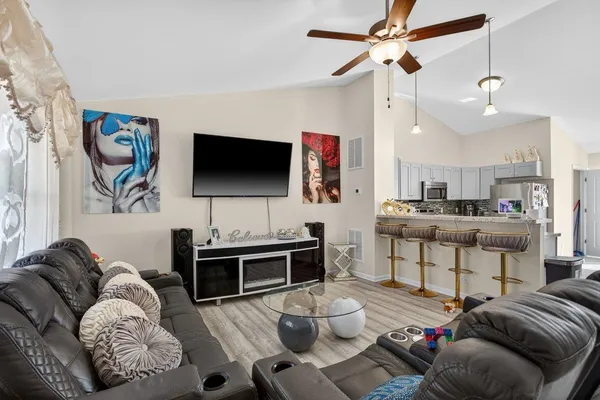 a living room with furniture and a flat screen tv