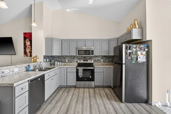 a kitchen with a sink stove and refrigerator