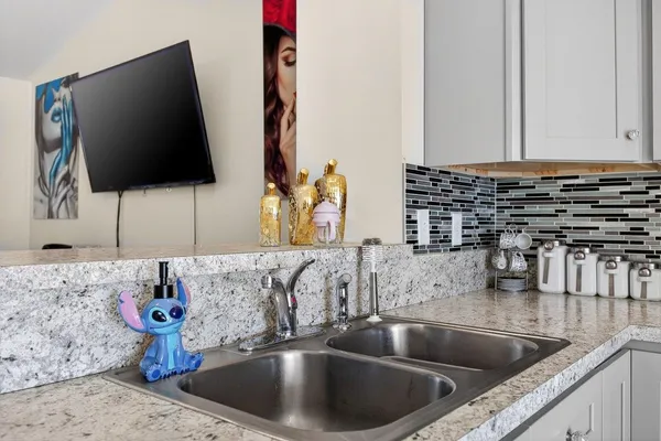 a kitchen with a faucet a sink and a stove