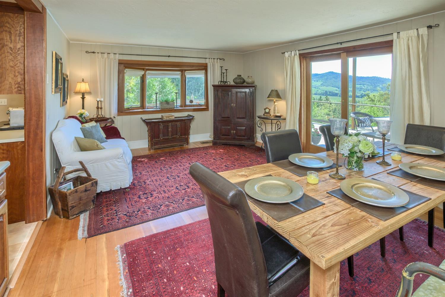 2820 Quail Run Road Talent, OR 97540 - Photo 15 of 30 a view of a dining room with furniture a rug and wooden floor