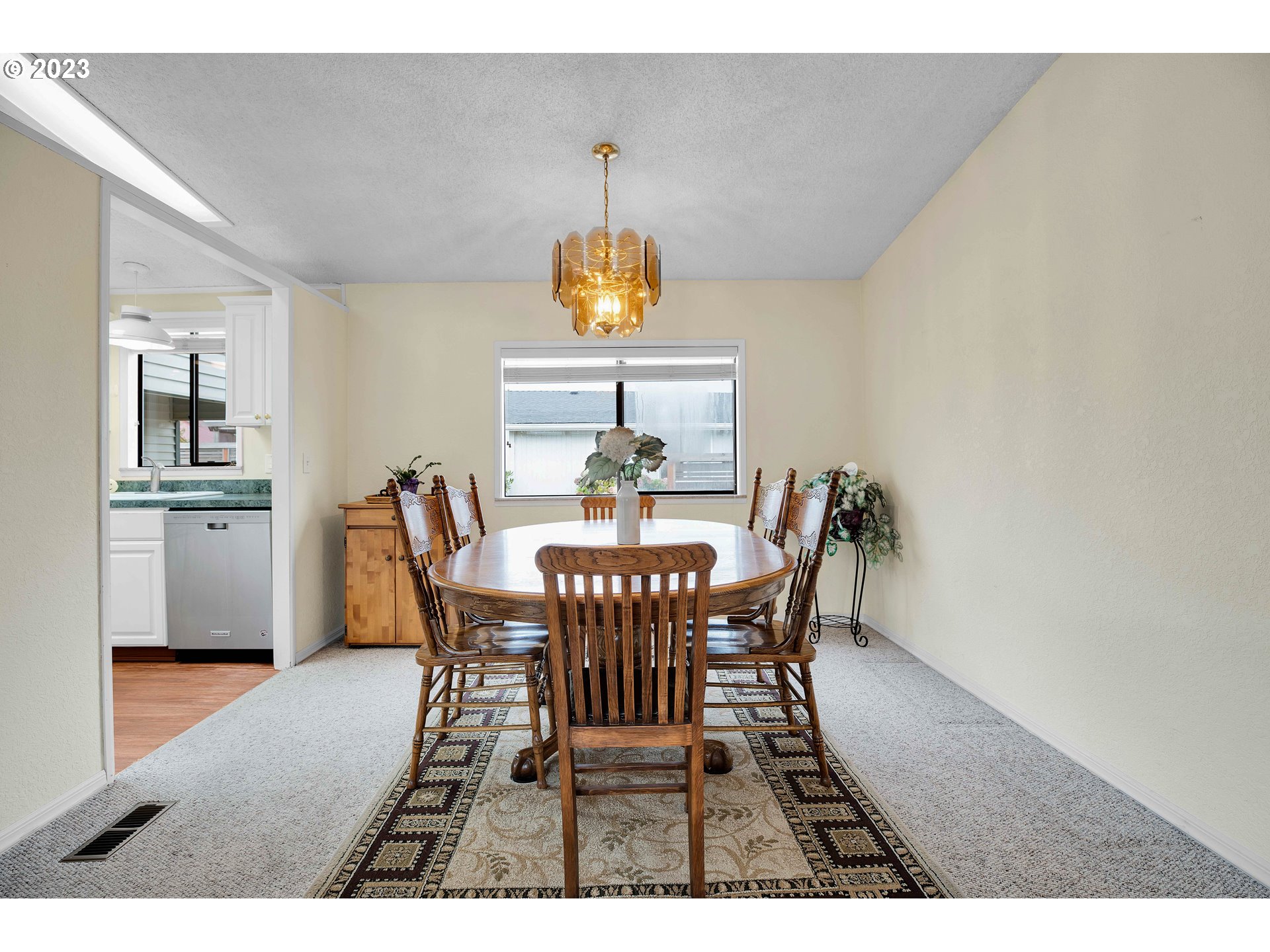 4304 Settlers Loop Forest Grove, OR 97116 - Photo 11 of 45 a view of a dining room with furniture window and wooden floor