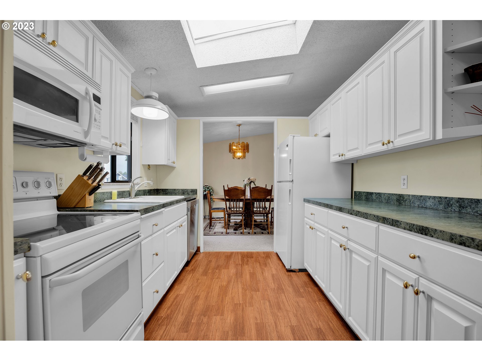 4304 Settlers Loop Forest Grove, OR 97116 - Photo 15 of 45 a kitchen with granite countertop a sink and cabinets