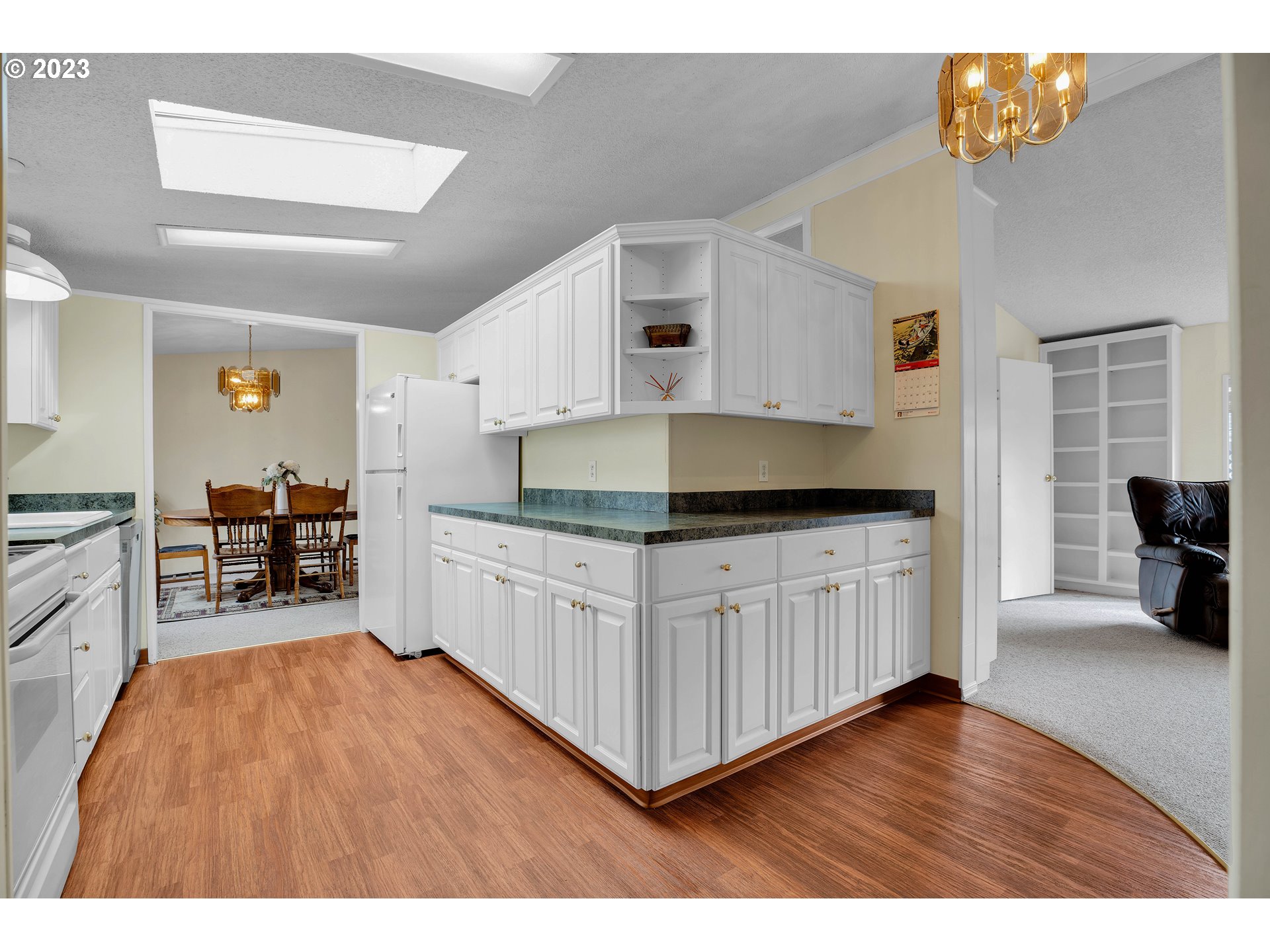 4304 Settlers Loop Forest Grove, OR 97116 - Photo 16 of 45 a kitchen with granite countertop white cabinets and appliances