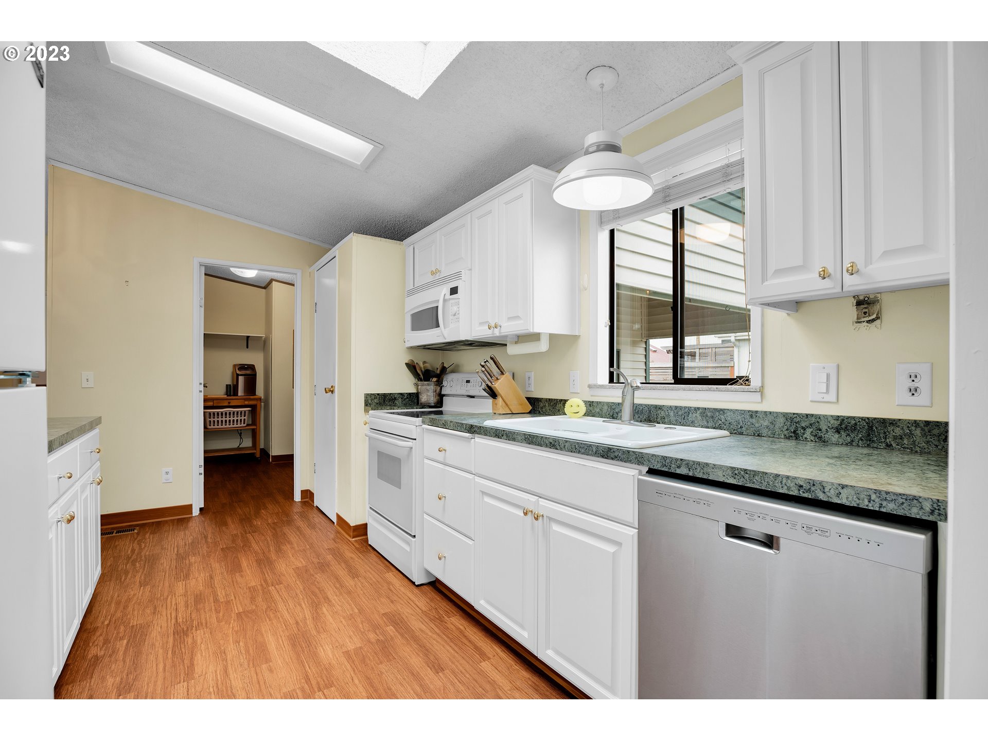 4304 Settlers Loop Forest Grove, OR 97116 - Photo 17 of 45 a kitchen with granite countertop a stove a sink and a refrigerator