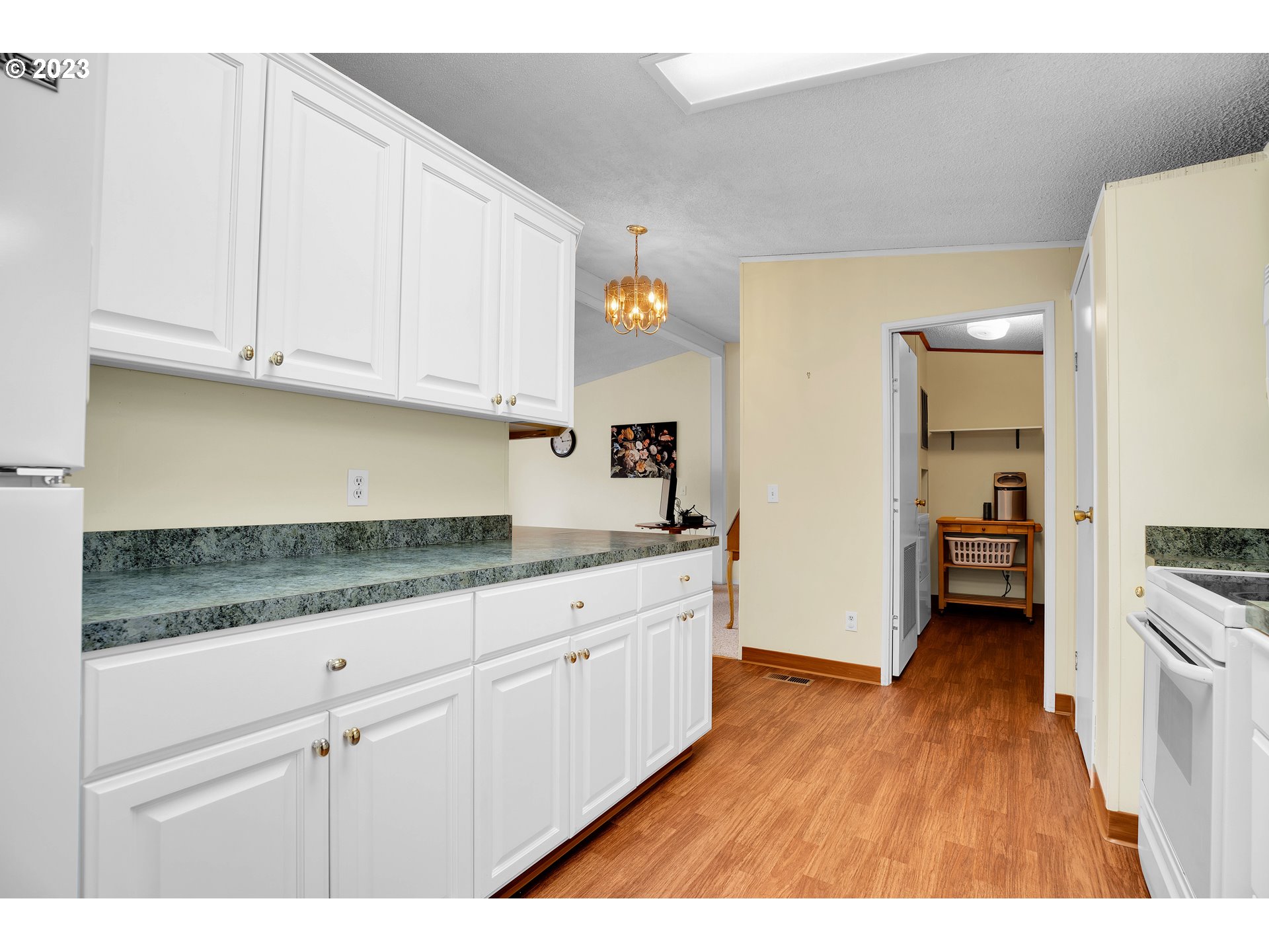 4304 Settlers Loop Forest Grove, OR 97116 - Photo 18 of 45 a kitchen with granite countertop white cabinets and white appliances