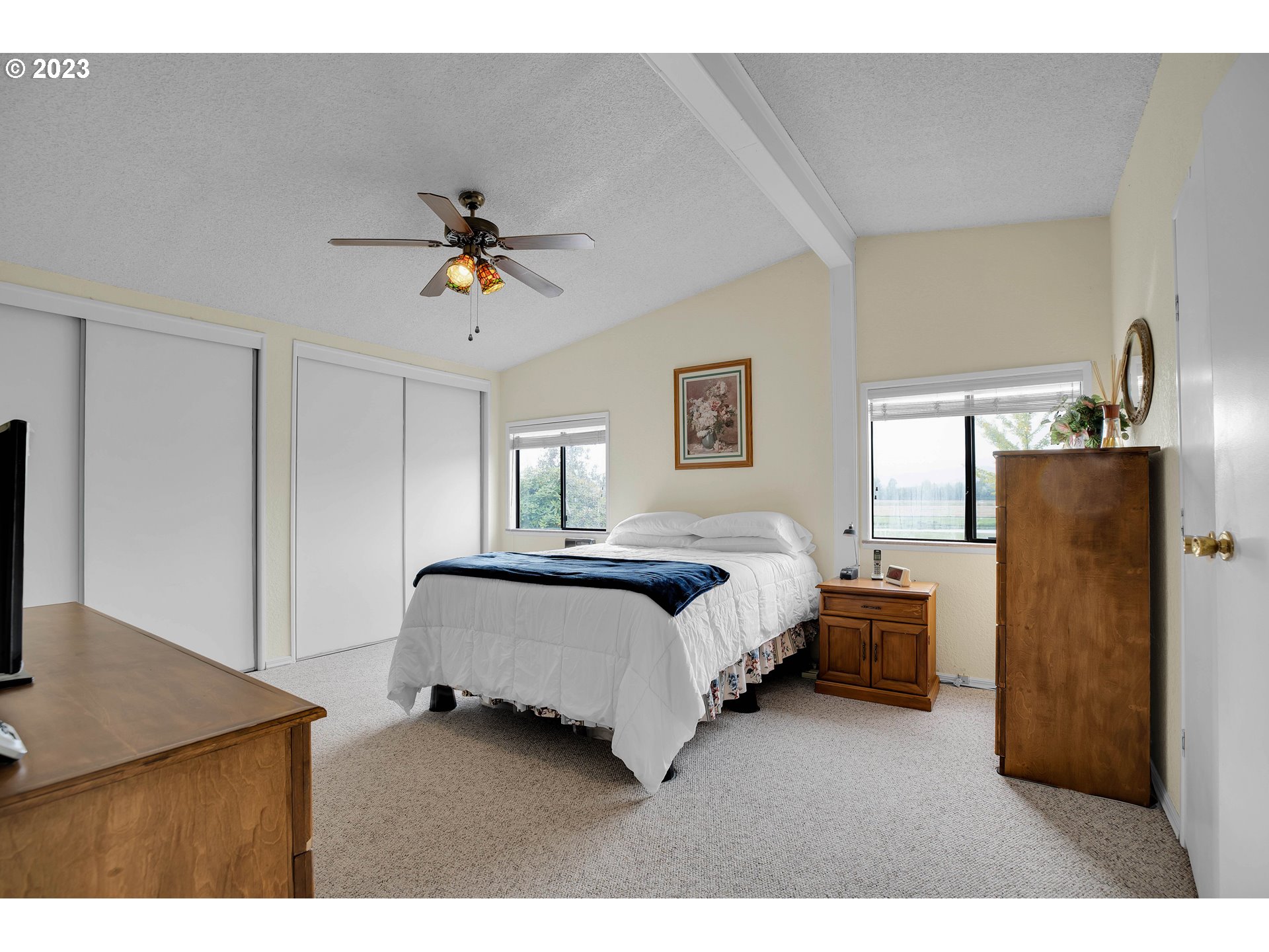 4304 Settlers Loop Forest Grove, OR 97116 - Photo 25 of 45 a bedroom with a bed and a chandelier