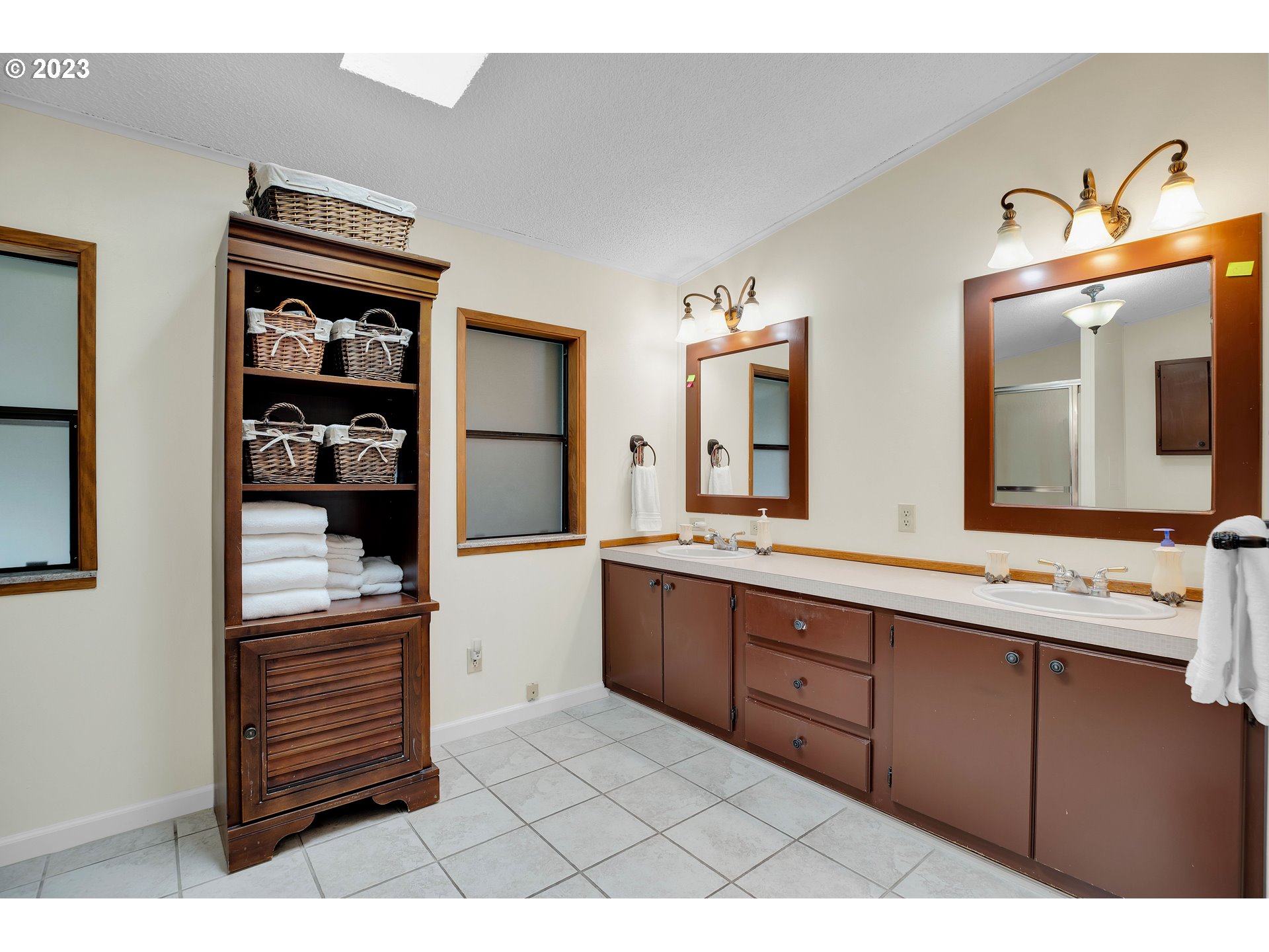 4304 Settlers Loop Forest Grove, OR 97116 - Photo 28 of 45 a bathroom with a sink a large mirror and a shower
